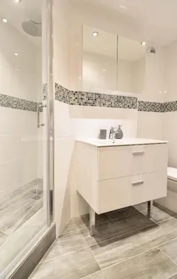 a white bathroom with a sink and a shower at Taragan - Totally Refurbished 3 bed apt, Central St Gervais! in Saint-Gervais-les-Bains