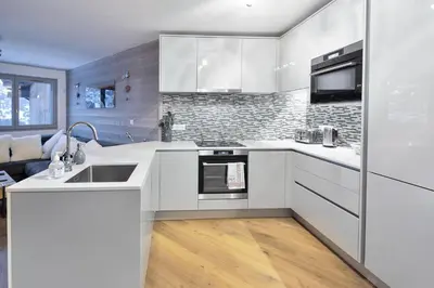 a white kitchen with a sink and a stove at Taragan - Totally Refurbished 3 bed apt, Central St Gervais! in Saint-Gervais-les-Bains