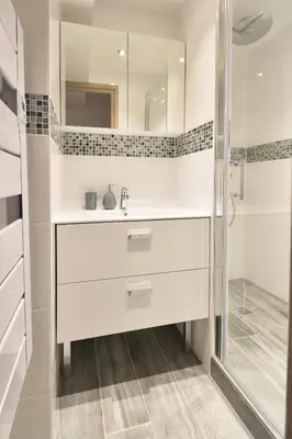 a white bathroom with a sink and a shower at Taragan - Totally Refurbished 3 bed apt, Central St Gervais! in Saint-Gervais-les-Bains