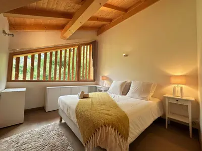 a bedroom with a large bed and a window at Chalet de standing avec parking à Sixt-Fer-à-Cheval - FR-1-624-132 in Sixt