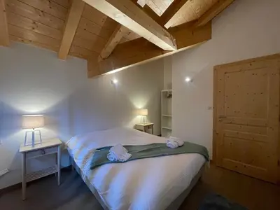 a small bedroom with a bed and a wooden ceiling at Chalet de standing avec parking à Sixt-Fer-à-Cheval - FR-1-624-132 in Sixt