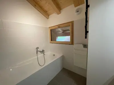a bathroom with a bath tub and a window at Chalet de standing avec parking à Sixt-Fer-à-Cheval - FR-1-624-132 in Sixt