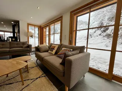 a living room with a couch and a large window at Chalet de standing avec parking à Sixt-Fer-à-Cheval - FR-1-624-132 in Sixt