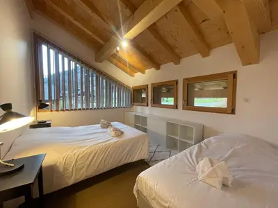 a bedroom with two beds and a desk and windows at Chalet de standing avec parking à Sixt-Fer-à-Cheval - FR-1-624-132 in Sixt