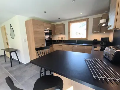 a kitchen with a large black table in a room at Chalet de standing avec parking à Sixt-Fer-à-Cheval - FR-1-624-132 in Sixt