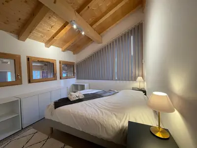 a bedroom with a bed and a table with a lamp at Chalet de standing avec parking à Sixt-Fer-à-Cheval - FR-1-624-132 in Sixt