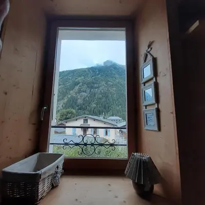 a window in a room with a view of a mountain at Appartement Chamonix Bossons in Chamonix-Mont-Blanc