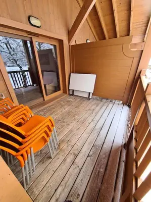 an inside view of a cabin with chairs and a stove at Appartement Le D12 Samoëns in Samoëns