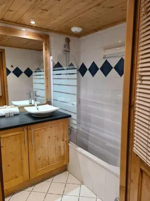 a bathroom with a sink and a shower at Appartement Le D12 Samoëns in Samoëns