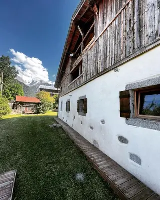 a side of a building with a grass yard at Wanderful Life MontBlanc refuge haut de gamme in Saint-Gervais-les-Bains