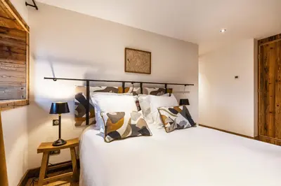 a bedroom with a large white bed with pillows at Wanderful Life MontBlanc refuge haut de gamme in Saint-Gervais-les-Bains