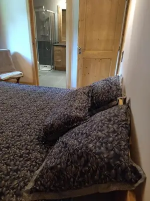 a bedroom with a bed with a blanket on it at RESIDENCE SASKYA in Samoëns