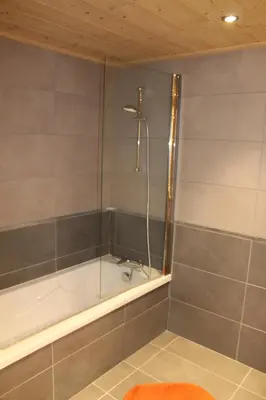 a bathroom with a shower with a bath tub at RESIDENCE SASKYA in Samoëns