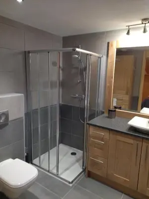 a bathroom with a shower with a toilet and a sink at RESIDENCE SASKYA in Samoëns