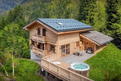 an overhead view of a wooden house with a hot tub at Chalet Choquette - OVO Network in Les Houches
