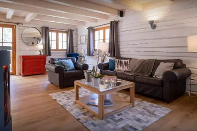 a living room with two couches and a coffee table at Chalet Choquette - OVO Network in Les Houches