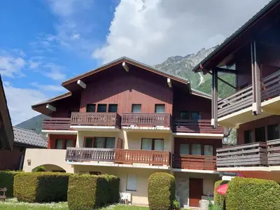 a large building with balconies on the side of it at Chamonix: Charmant 2 pièces avec parking proche centre - FR-1-517-66 in Chamonix-Mont-Blanc