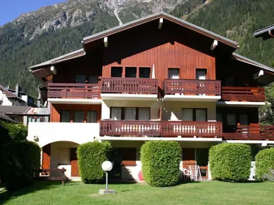 a large apartment building with a large balcony at Chamonix: Charmant 2 pièces avec parking proche centre - FR-1-517-66 in Chamonix-Mont-Blanc