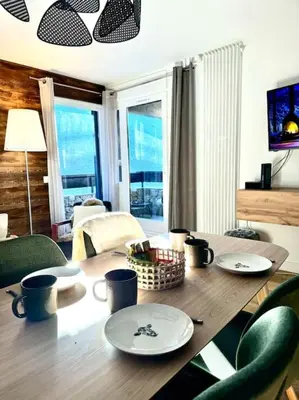 a wooden table with plates and cups on top of it at Le LihamWood in Megève