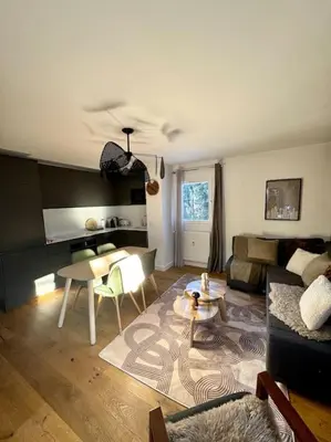 a living room with a couch and a table at Le LihamWood in Megève
