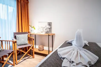 a bedroom with a bed with a stuffed animal on it at Le Savoy - Terrasse avec vue sur le Mont-Blanc in Chamonix-Mont-Blanc