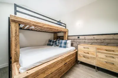 a bedroom with a bunk bed and a dresser at Kotibé Chamonix - BY EMERALD STAY in Chamonix-Mont-Blanc