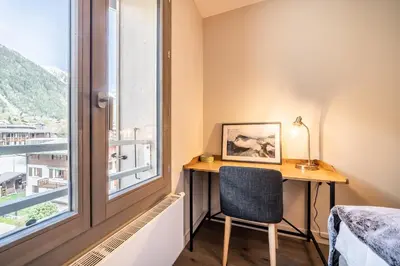 a desk in a room with a window and a chair at Kotibé Chamonix - BY EMERALD STAY in Chamonix-Mont-Blanc