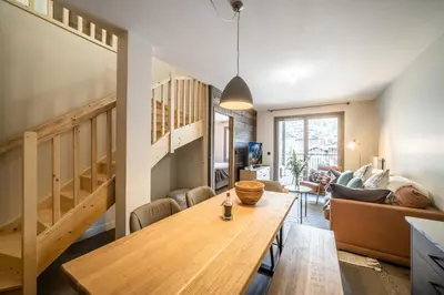 a living room with a wooden table and a couch at Kotibé Chamonix - BY EMERALD STAY in Chamonix-Mont-Blanc