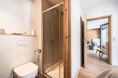 a bedroom with a large bed with wooden walls at Kabano Chamonix - BY EMERALD STAY in Chamonix-Mont-Blanc