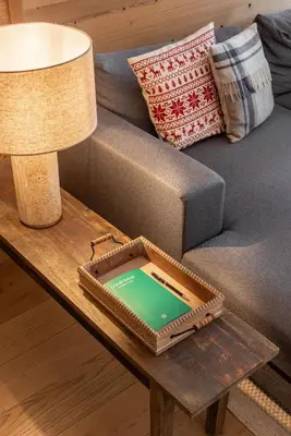 a table with a laptop on top of a couch at Kabano Chamonix - BY EMERALD STAY in Chamonix-Mont-Blanc