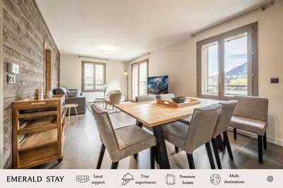 a dining room with a table and chairs at Kalmia Chamonix - BY EMERALD STAY in Chamonix-Mont-Blanc