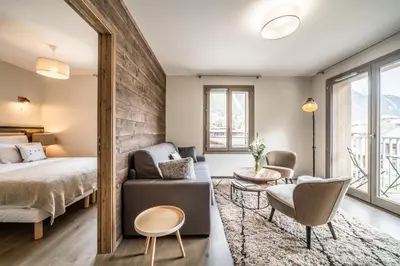 a bedroom with a bed and a couch and a table at Kalmia Chamonix - BY EMERALD STAY in Chamonix-Mont-Blanc