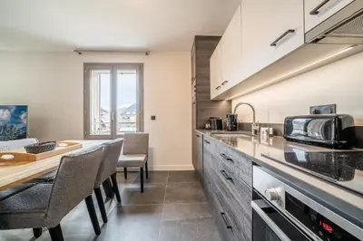 a kitchen with a table and chairs and a counter top at Kalmia Chamonix - BY EMERALD STAY in Chamonix-Mont-Blanc