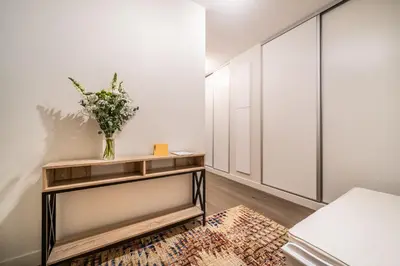 a bedroom with a table with a vase of flowers on it at Kalmia Chamonix - BY EMERALD STAY in Chamonix-Mont-Blanc