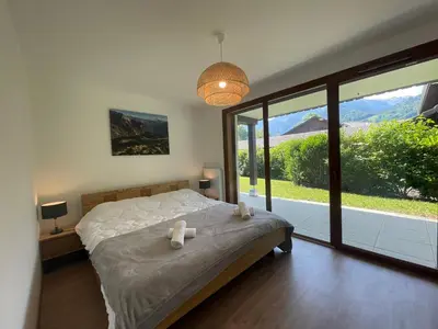 a bedroom with a large bed and a large window at Appartement familial à Samoëns, animaux admis, Wi-Fi inclus - FR-1-624-133 in Samoëns