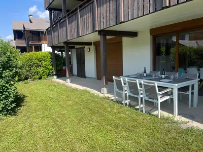 a table and chairs sitting outside of a house at Appartement familial à Samoëns, animaux admis, Wi-Fi inclus - FR-1-624-133 in Samoëns