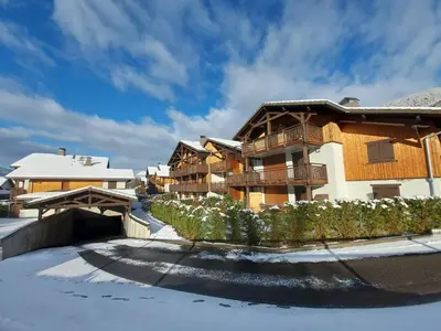 a apartment building with snow on the ground at Appartement familial à Samoëns, animaux admis, Wi-Fi inclus - FR-1-624-133 in Samoëns