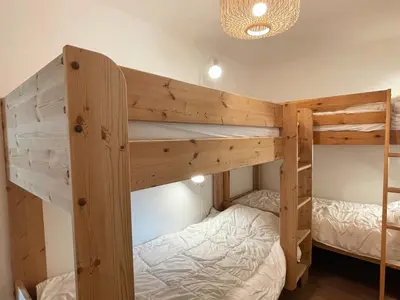 a couple of bunk beds in a room at Appartement familial à Samoëns, animaux admis, Wi-Fi inclus - FR-1-624-133 in Samoëns