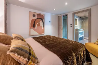 a bedroom with a bed and a couch at Chalet Mozart I Le Chalet Club in Megève