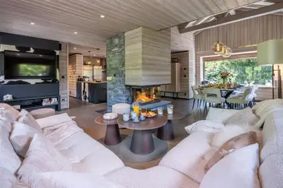 a living room with a couch and a fireplace at Chalet Mozart I Le Chalet Club in Megève