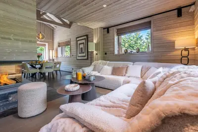 a living room with a couch and a fireplace at Chalet Mozart I Le Chalet Club in Megève