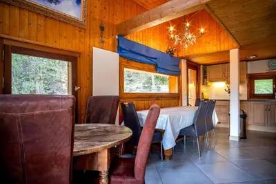 a dining room with a table and chairs at Datcha of Sky -Jardin - Calme - 180 vues - 9 chambres & Studio Appt in Les Houches