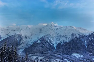a snow covered mountain range with trees in the foreground at Datcha of Sky -Jardin - Calme - 180 vues - 9 chambres & Studio Appt in Les Houches