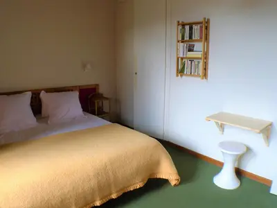 a bedroom with a bed and a table and a shelf at 2 pièces confortable & lumineux au centre de Samoëns - Animaux admis et parking inclus - FR-1-629-126 in Samoëns