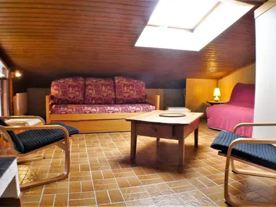 a room with a bed and a table and chairs at 2 pièces confortable & lumineux au centre de Samoëns - Animaux admis et parking inclus - FR-1-629-126 in Samoëns