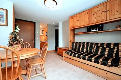 a living room with a table and a couch at Résidence Les Sapins - Les Sapins 2 MAE-0514 in Les Houches