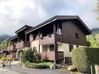 a large house with a balcony on top of it at Résidence Les Sapins - Les Sapins 2 MAE-0514 in Les Houches