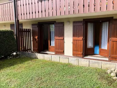 a row of wooden doors on a house at Résidence Les Sapins - Les Sapins 2 MAE-0514 in Les Houches