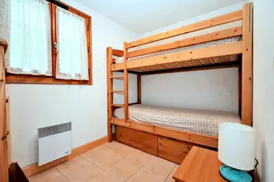 a bedroom with two bunk beds and a desk at Résidence Les Sapins - Les Sapins 2 MAE-0514 in Les Houches