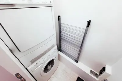 a laundry room with a washer and dryer at Les Aiguilles du Brevent - Grand Appt Renove - Central - Terrasse avec Vue in Chamonix-Mont-Blanc